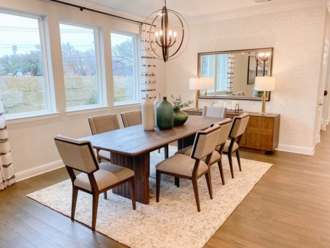 A dining room with an old dark table and chairs