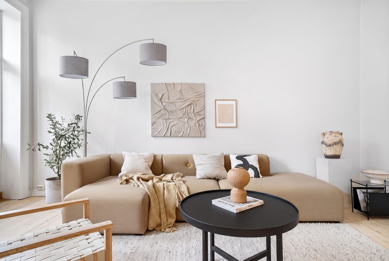 The same living room with a three arm arc floor lamp placed in it